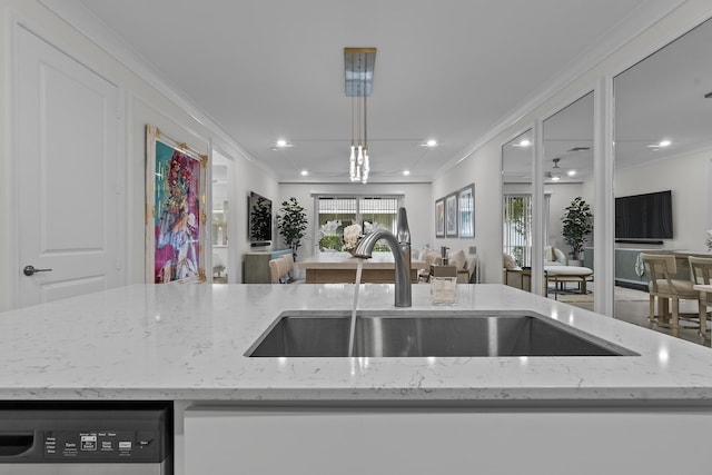 kitchen with light stone counters, ornamental molding, open floor plan, a sink, and dishwashing machine