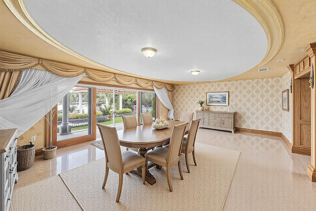 dining space featuring baseboards, visible vents, and wallpapered walls