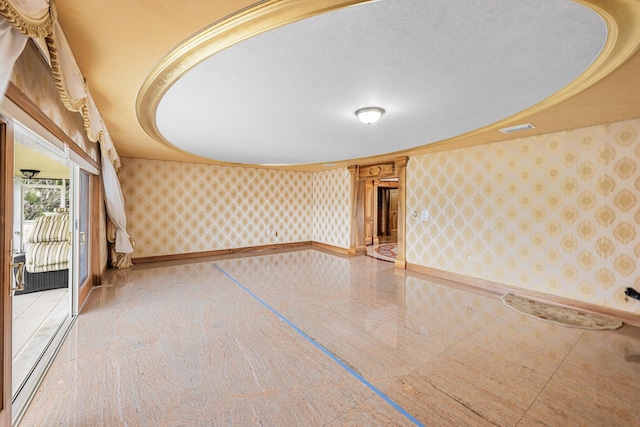 spare room featuring wallpapered walls, visible vents, baseboards, and crown molding