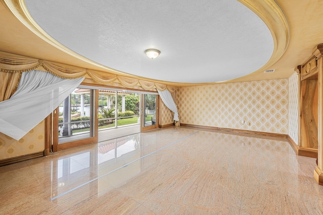 bonus room featuring wallpapered walls, granite finish floor, baseboards, and a textured ceiling