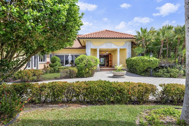 mediterranean / spanish-style house with a tiled roof and stucco siding