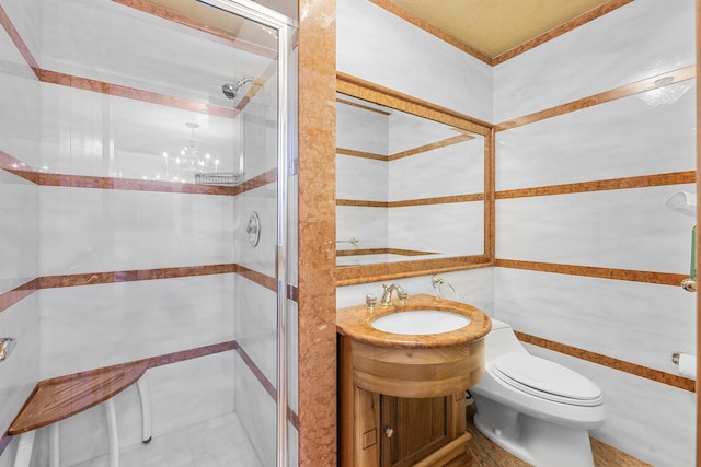 full bathroom with tile walls, a shower stall, toilet, and vanity