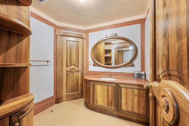 bathroom with tile walls, vanity, and tile patterned floors