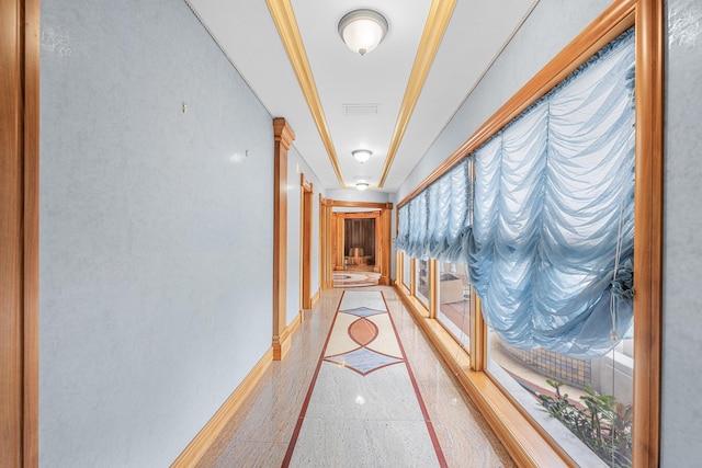 hall with light speckled floor and baseboards