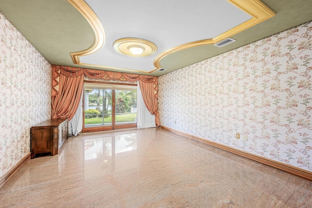 empty room with wallpapered walls, baseboards, granite finish floor, and visible vents