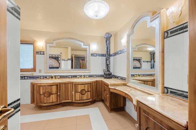 full bath with double vanity, a sink, and tile patterned floors