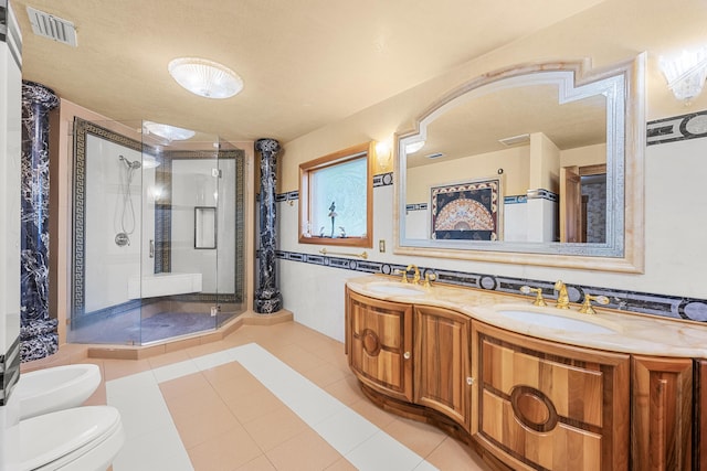 bathroom featuring a stall shower, visible vents, a sink, and a bidet