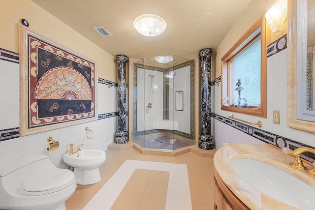 full bath featuring visible vents, toilet, vanity, a shower stall, and a bidet