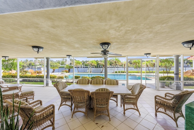 sunroom featuring a ceiling fan