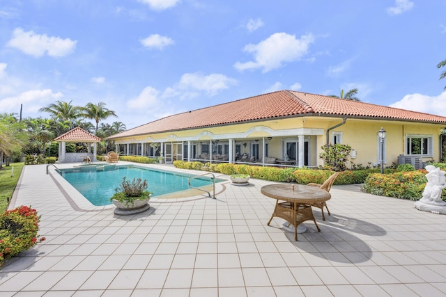 view of pool featuring a gazebo, central AC, a patio area, and a pool with connected hot tub