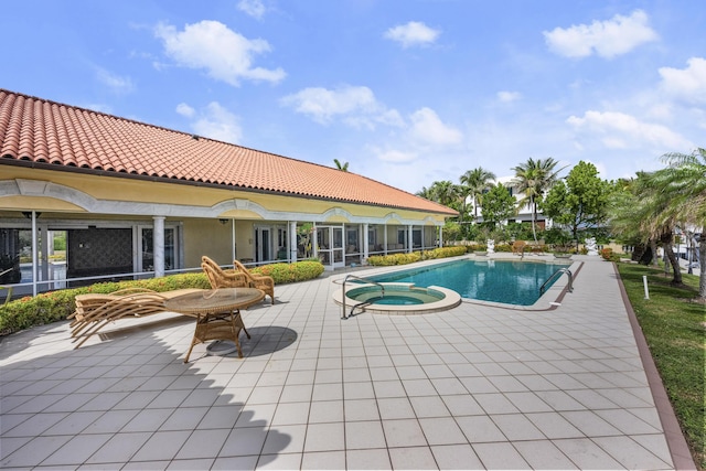 view of pool with a patio and a pool with connected hot tub