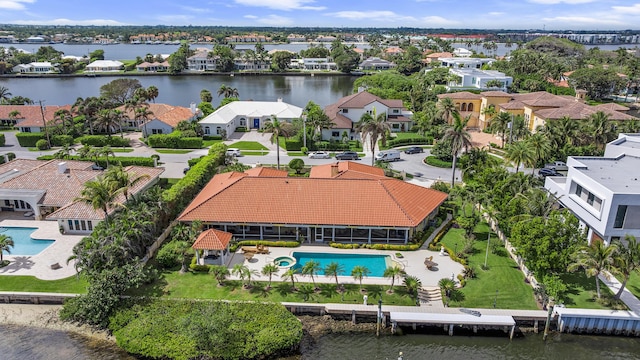 drone / aerial view featuring a water view and a residential view