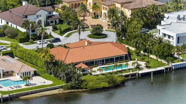 drone / aerial view with a water view and a residential view