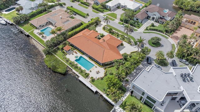 drone / aerial view with a water view and a residential view