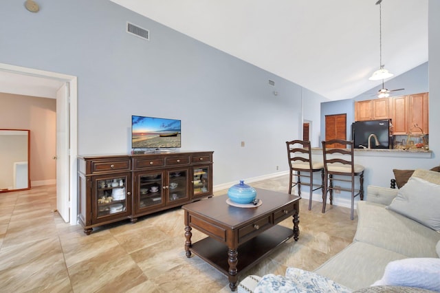 living room featuring visible vents, baseboards, high vaulted ceiling, and a ceiling fan