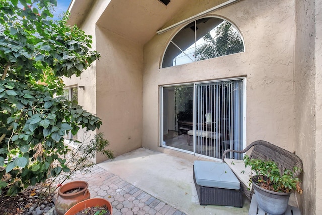 exterior space featuring a patio area and stucco siding