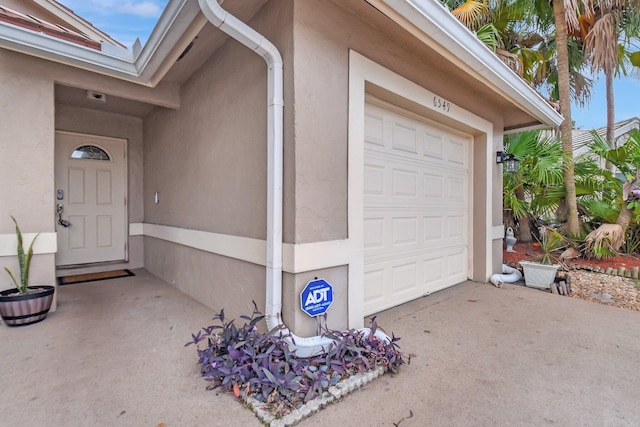 garage with concrete driveway