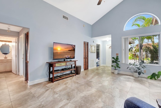 interior space featuring a ceiling fan, visible vents, and baseboards