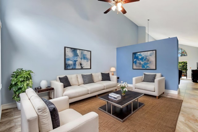 living room featuring baseboards, high vaulted ceiling, and ceiling fan