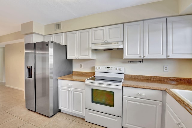 kitchen with electric stove, stainless steel fridge, under cabinet range hood, and white cabinetry