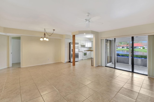 unfurnished living room with ceiling fan with notable chandelier, light tile patterned flooring, and baseboards