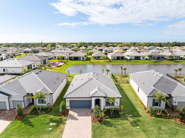 drone / aerial view with a water view and a residential view