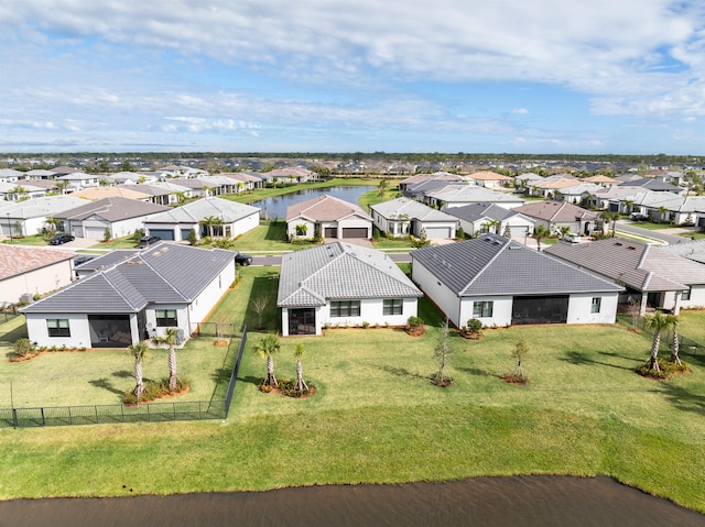 bird's eye view featuring a water view and a residential view