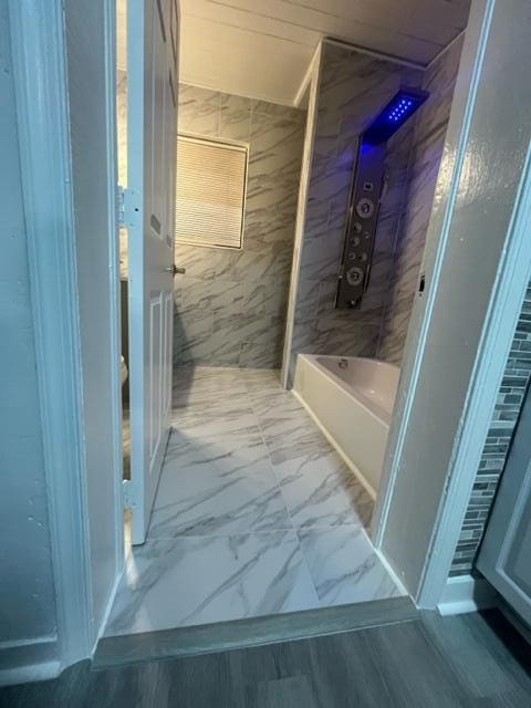 full bathroom featuring marble finish floor