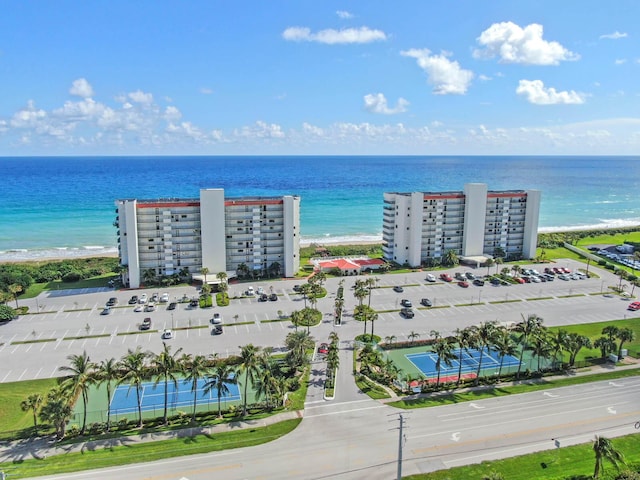 drone / aerial view featuring a beach view and a water view