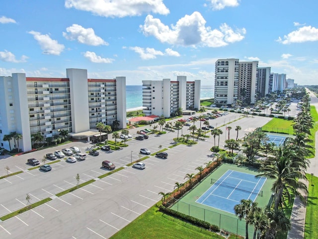 birds eye view of property featuring a water view and a city view