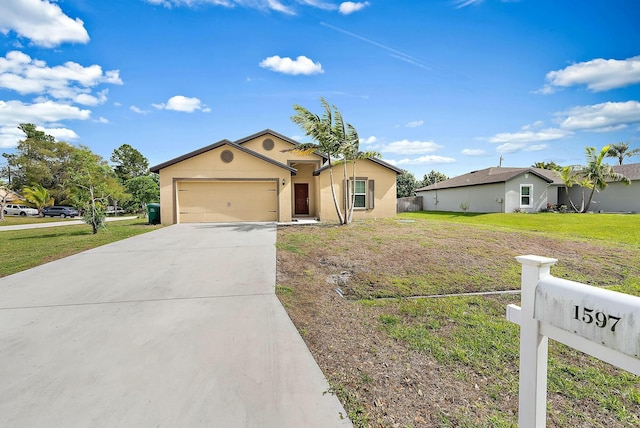 view of front of property featuring an attached garage, fence, driveway, stucco siding, and a front yard