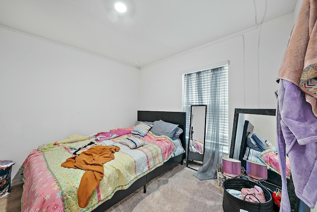 carpeted bedroom featuring crown molding