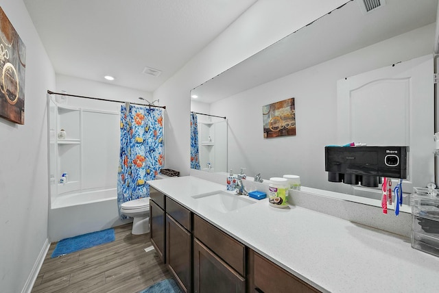 bathroom with visible vents, toilet, shower / bath combo, vanity, and wood finished floors