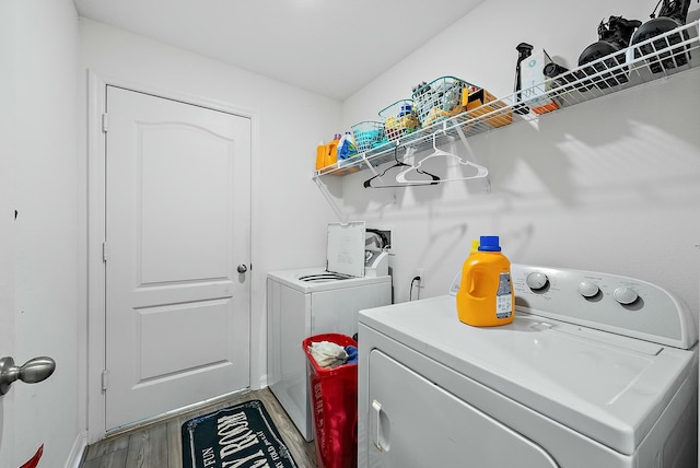 laundry area featuring laundry area, separate washer and dryer, and light wood-style floors