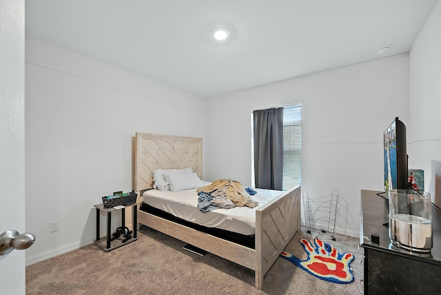 carpeted bedroom featuring baseboards