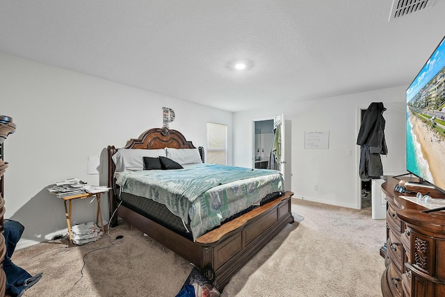 bedroom featuring baseboards, visible vents, a textured ceiling, and light colored carpet