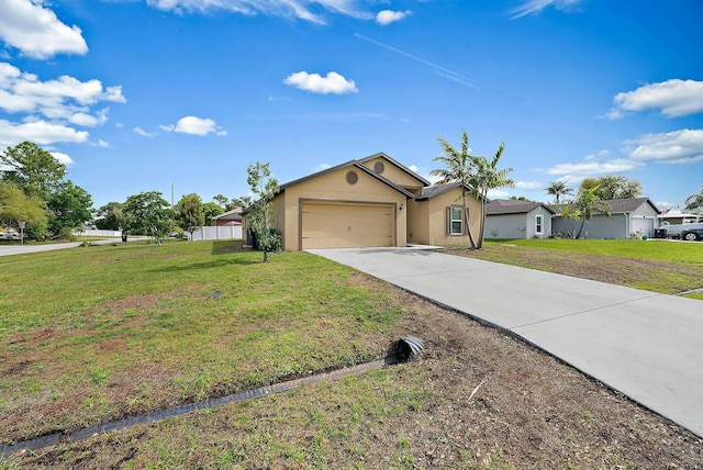 single story home featuring an attached garage, a front lawn, concrete driveway, and stucco siding