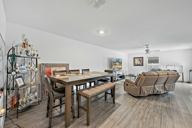 dining space featuring ceiling fan, light wood-style flooring, and visible vents