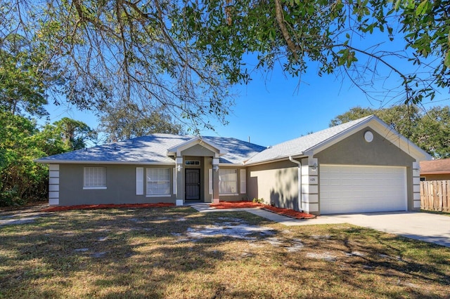 single story home featuring a garage, driveway, a front yard, and stucco siding