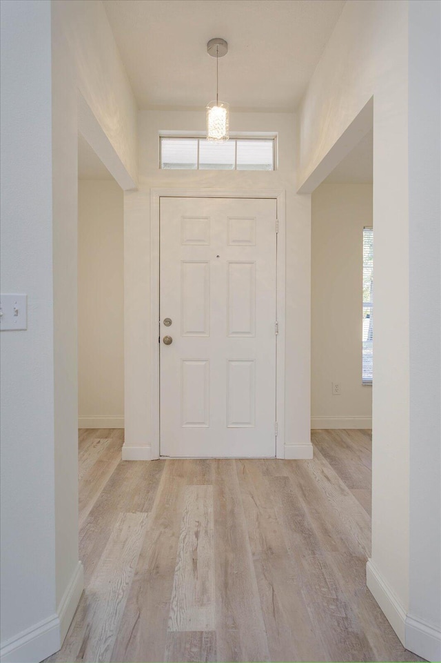 entrance foyer featuring light wood-style floors and baseboards