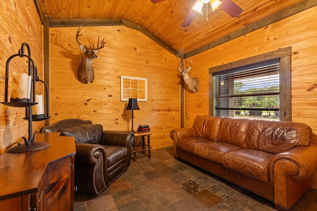 living room featuring wooden walls, a ceiling fan, wood ceiling, vaulted ceiling, and stone finish flooring