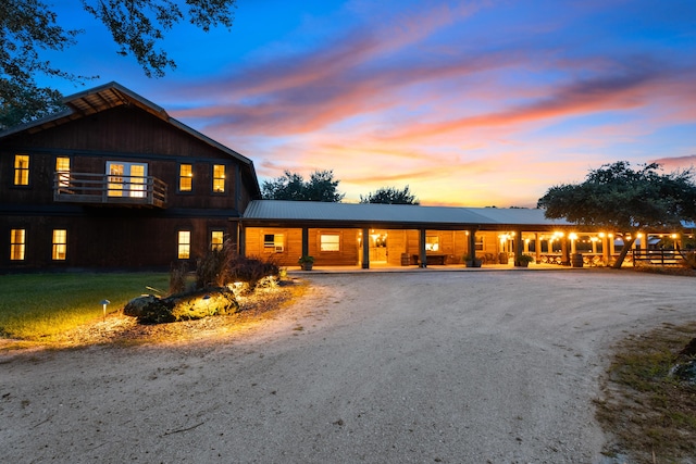 view of front of home featuring metal roof and driveway