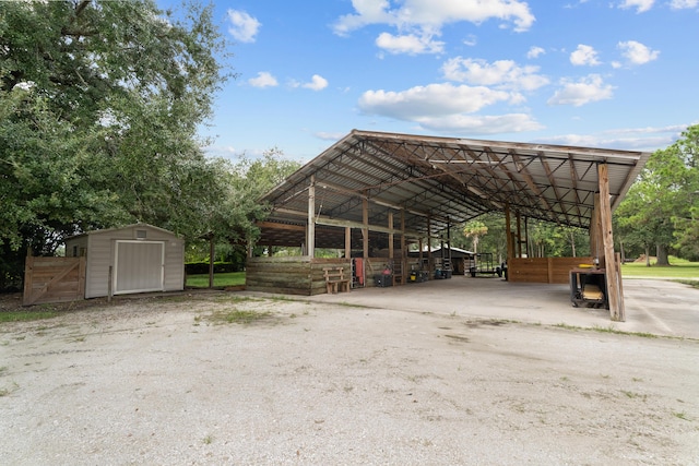 view of car parking featuring a storage unit and a detached carport