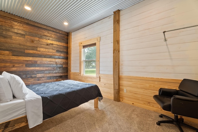 carpeted bedroom featuring recessed lighting and wood walls