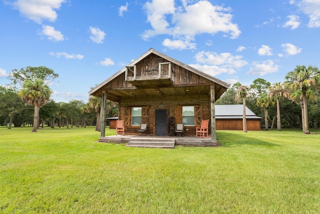 back of property featuring a yard