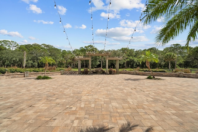 view of property's community with a patio area and a pergola