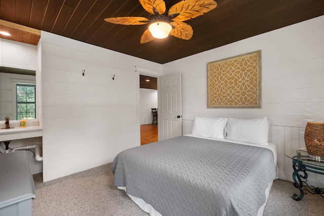 carpeted bedroom featuring ceiling fan and wooden ceiling