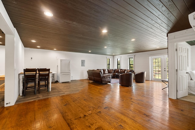 living room with french doors, recessed lighting, wood finished floors, wooden ceiling, and electric panel