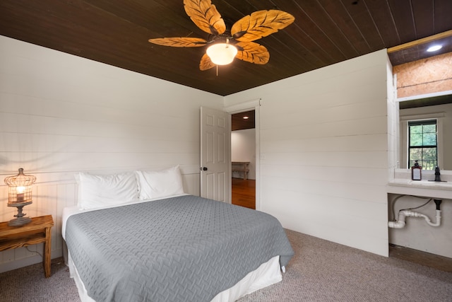 bedroom with wooden ceiling and a ceiling fan