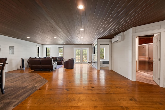 living area featuring a wall unit AC, wooden ceiling, wood finished floors, french doors, and recessed lighting